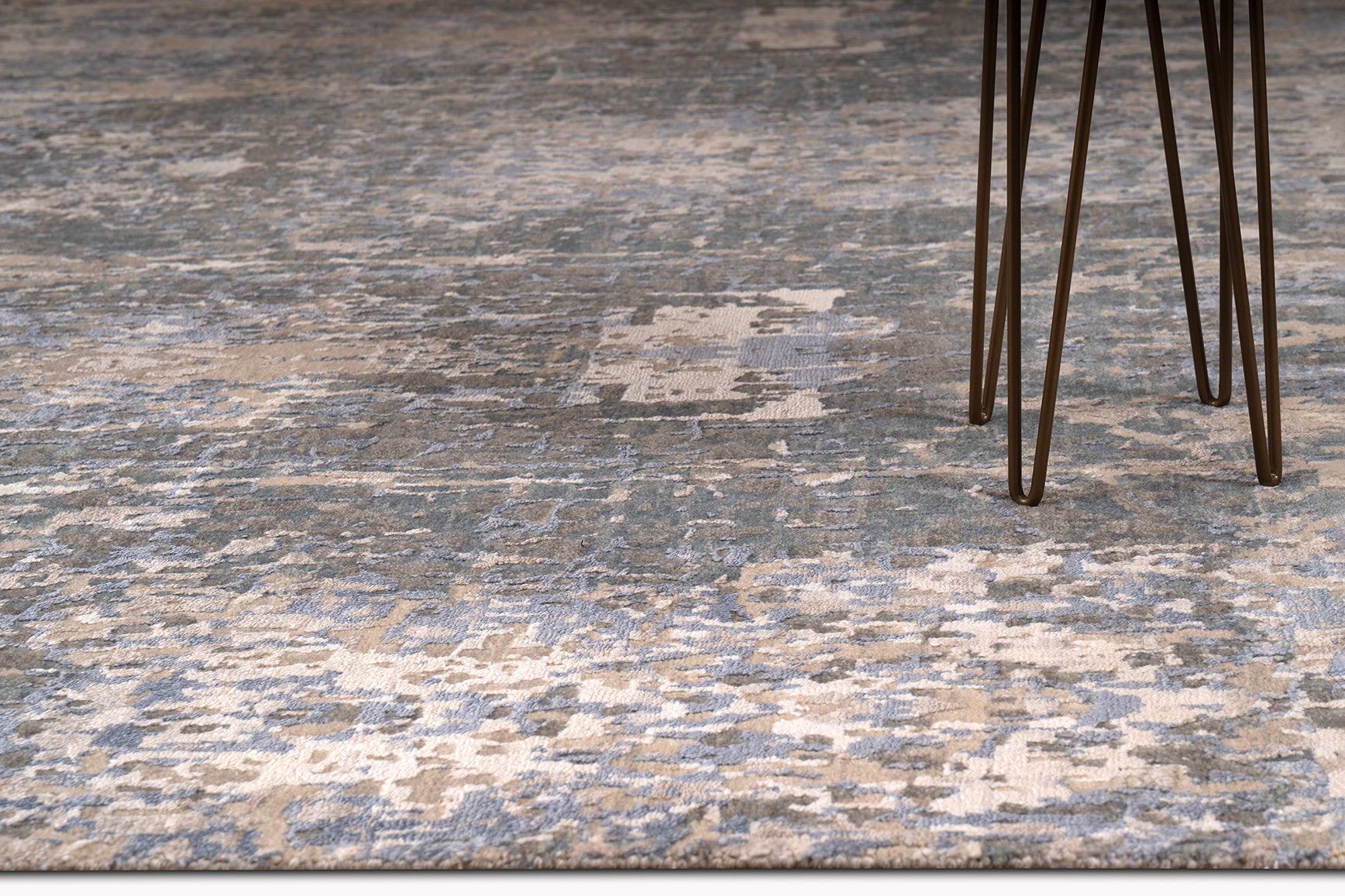 living room rug with intricate pattern in blue, grey and brown shades