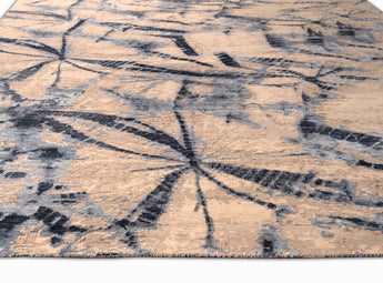 beautiful area rug with butterfly like patterns in multiple shades of blue and beige