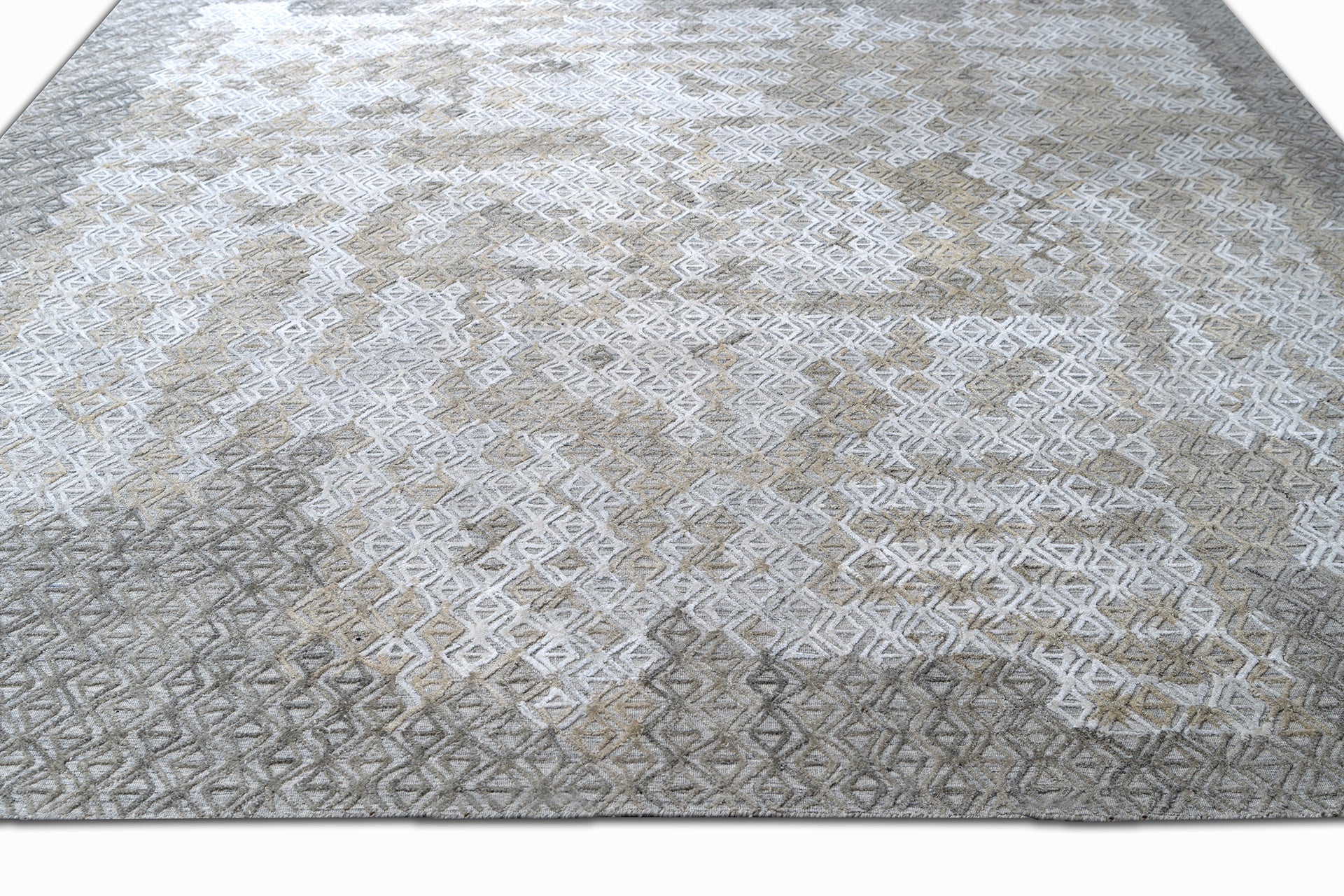 handmade are rug with simple patterns in grey and white colors - on the floor view