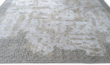 handmade are rug with simple patterns in grey and white colors - on the floor view