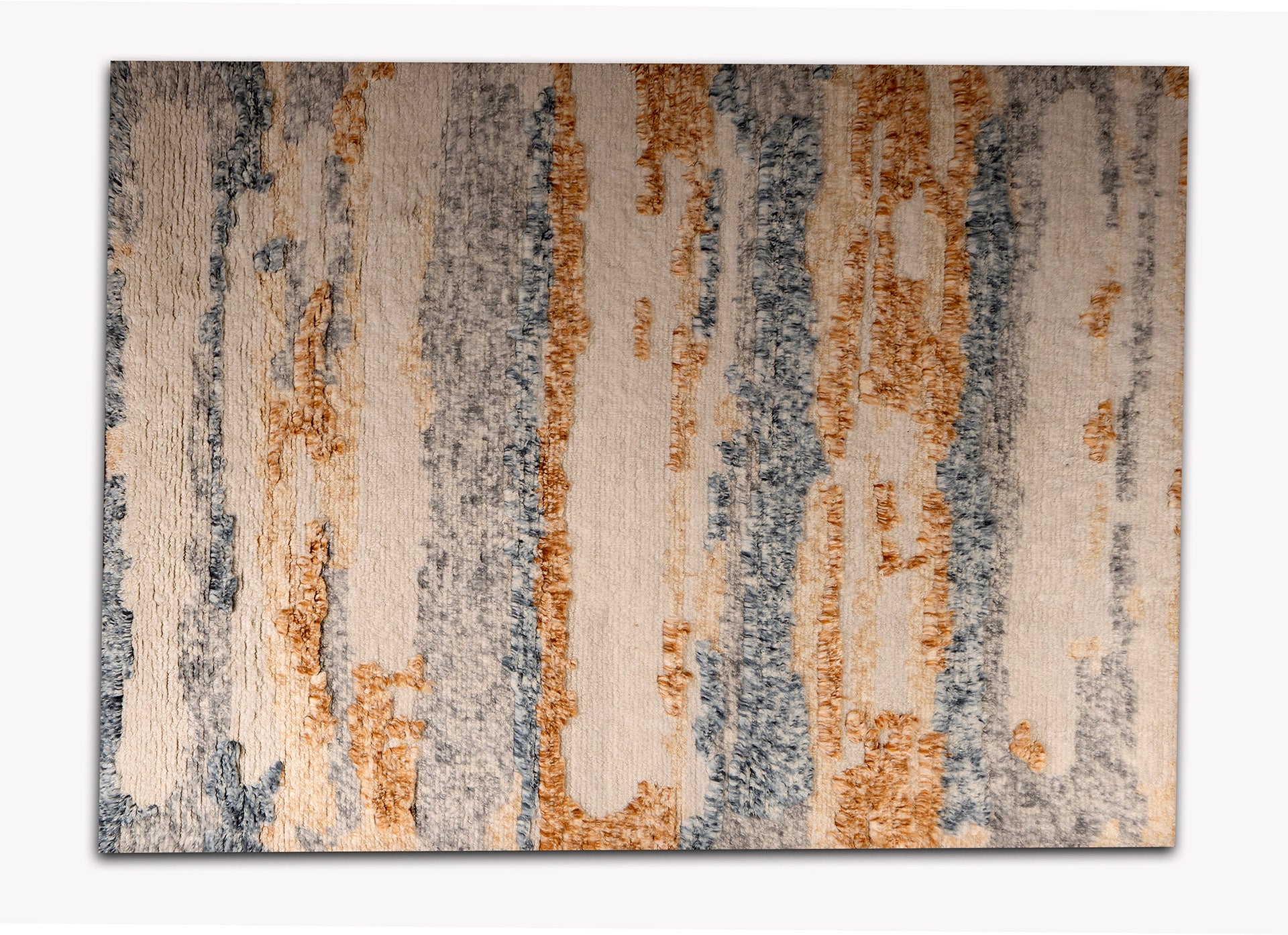 Plush area rug with bulging patterns in rust , blue and white colors